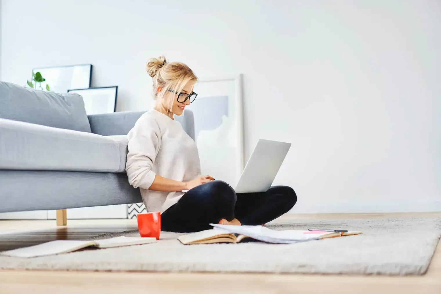 woman sitting on floor focusing on laptop 1