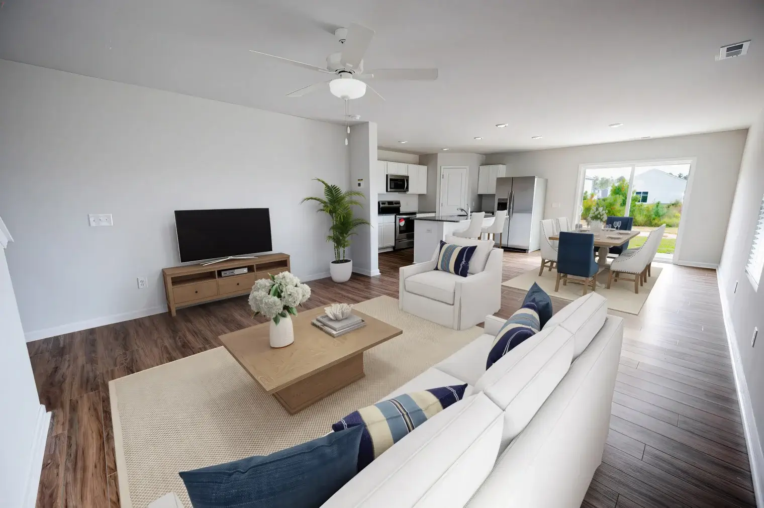 Bolivia, NC, Homes for Rent - Carolina Crossing - Living Room with White Walls, Luxury Vinyl Plank Flooring, Couch, Coffee Table, Media Cabinet, and TV.