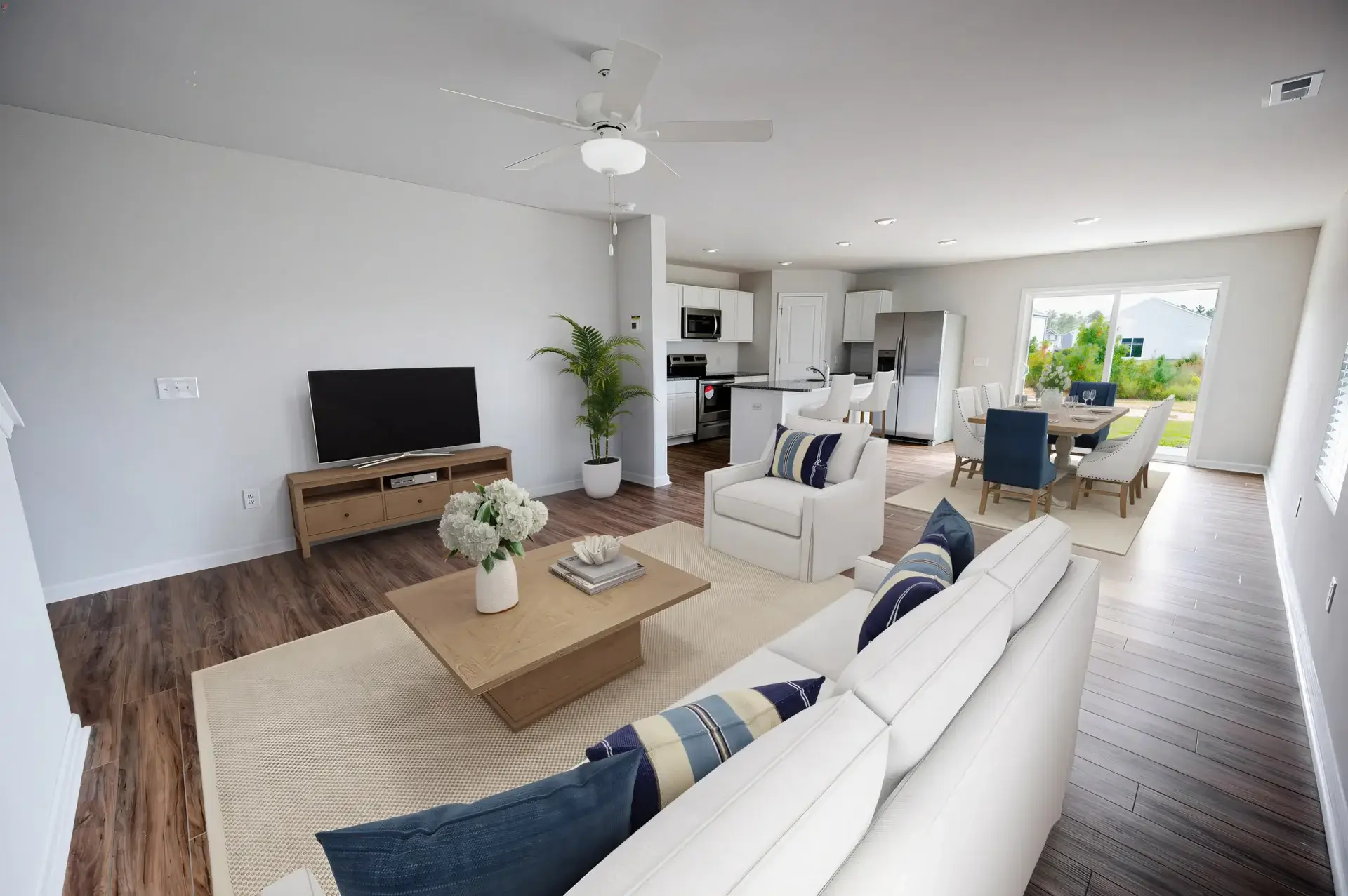 Bolivia, NC, Homes for Rent - Carolina Crossing - Living Room with White Walls, Luxury Vinyl Plank Flooring, Couch, Coffee Table, Media Cabinet, and TV.